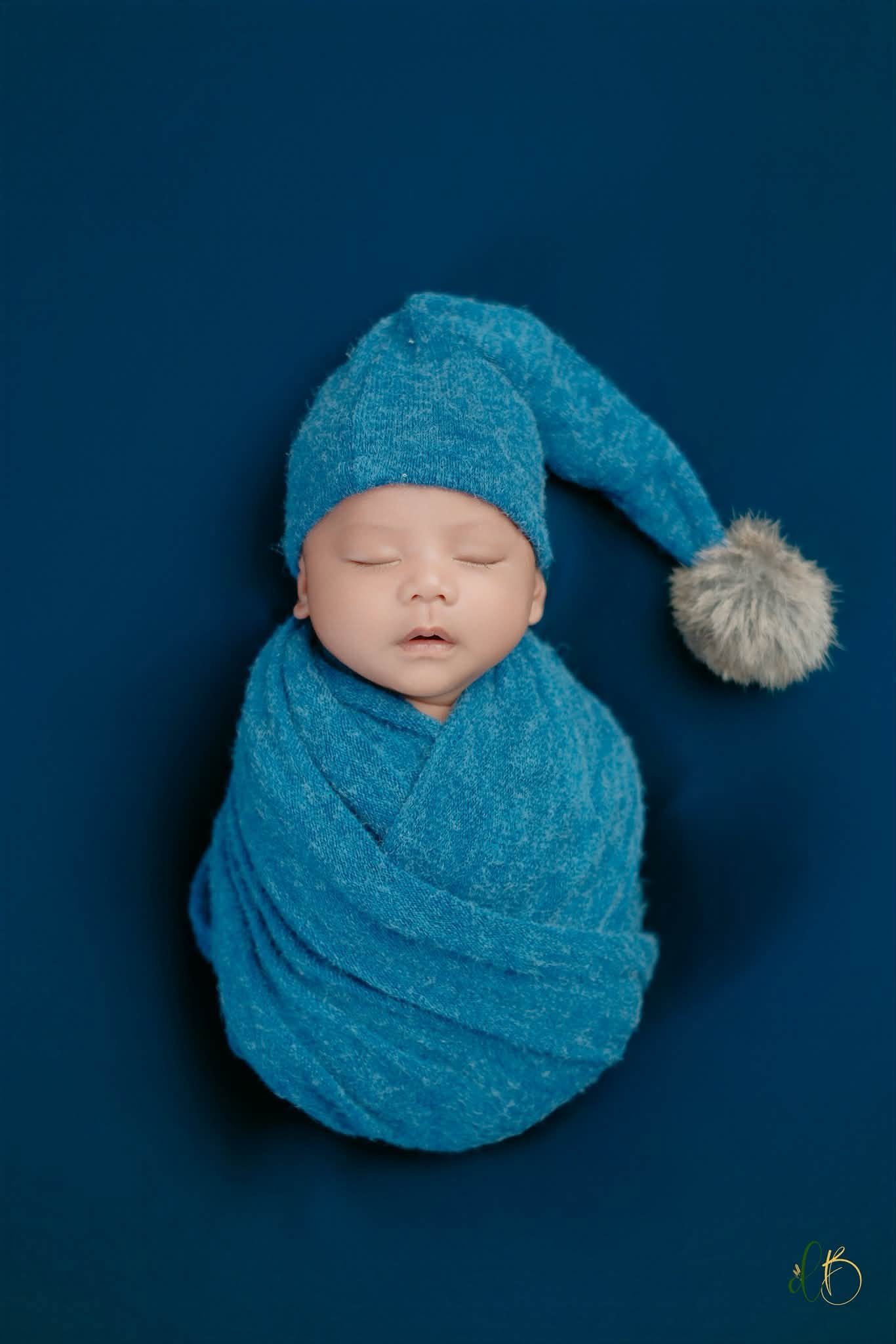 Newborn in a blue sleepy cap